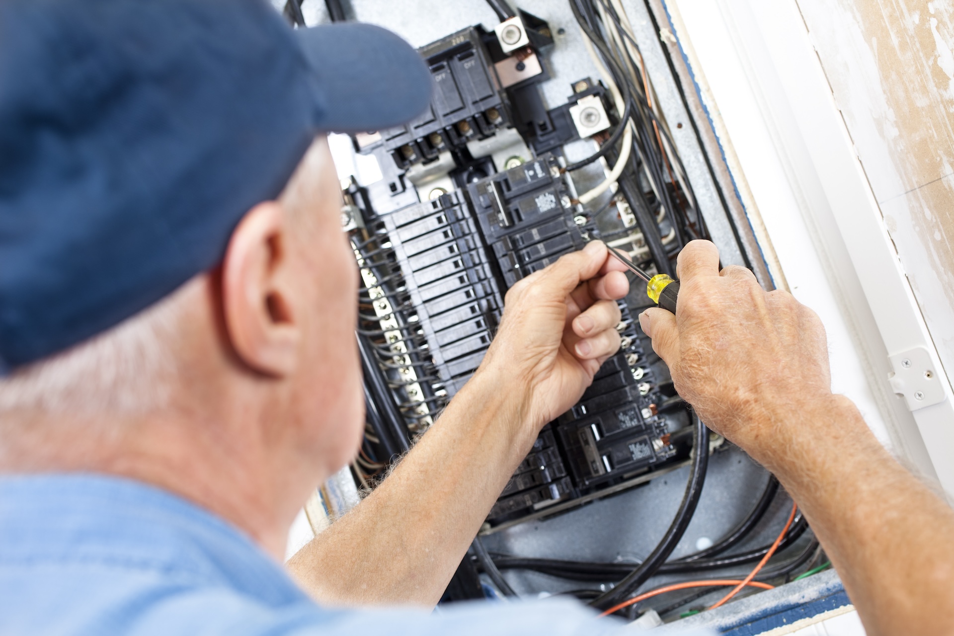 Electrician doing electrical work in breaker box