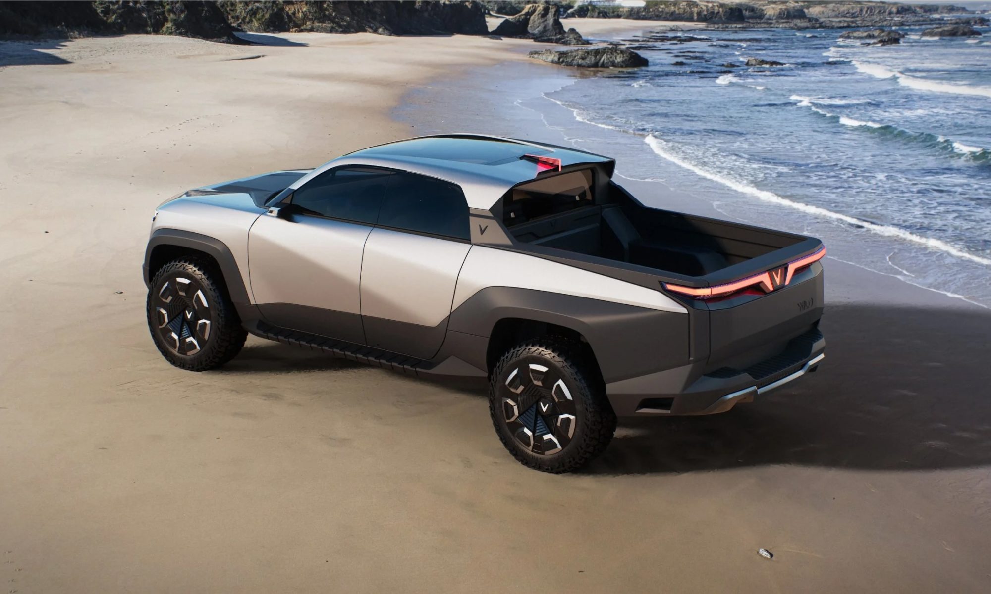Vinfast Wild Electric Pickup parked on the beach by waves