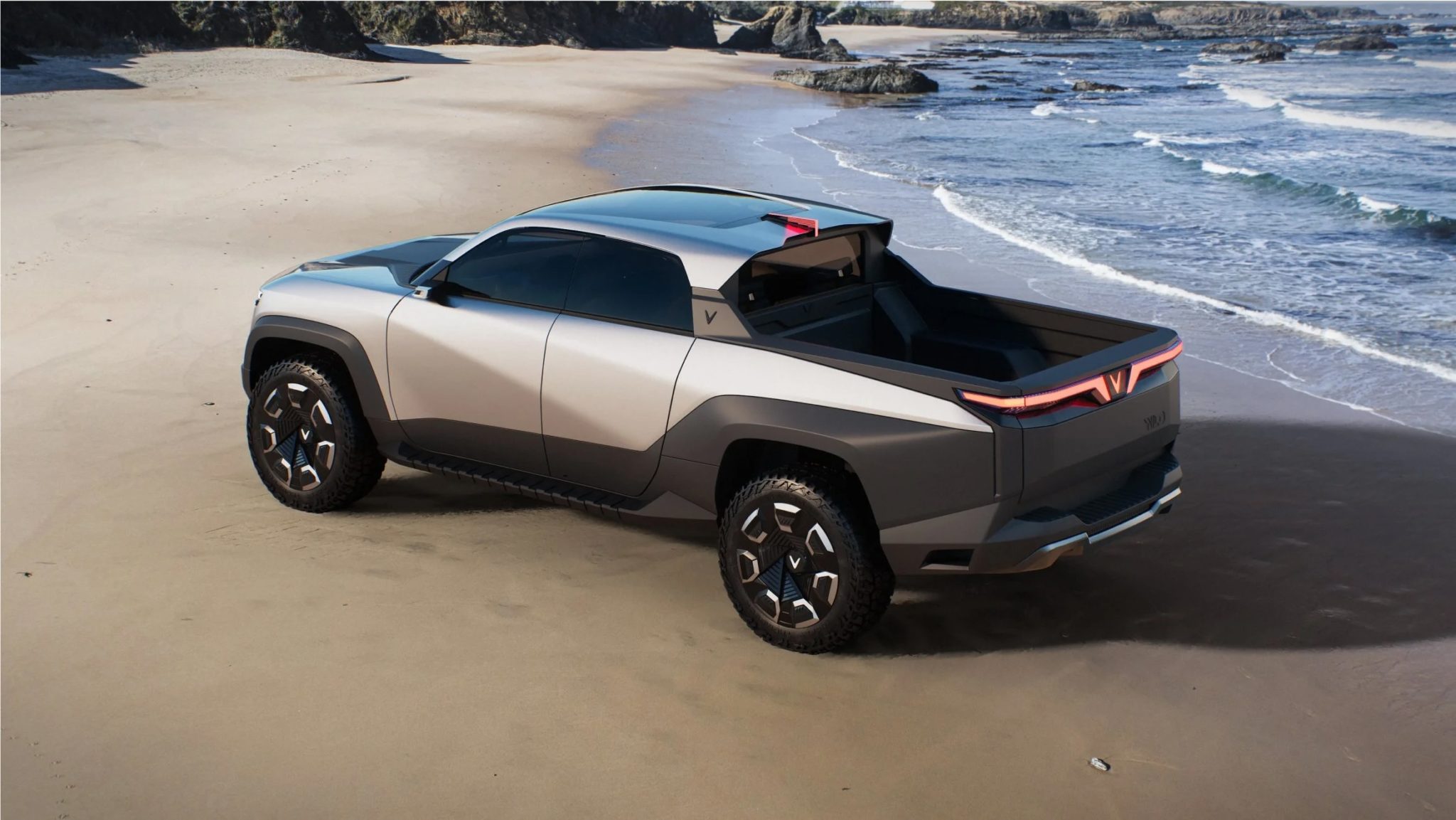 Vinfast Wild Electric Pickup parked on the beach by waves