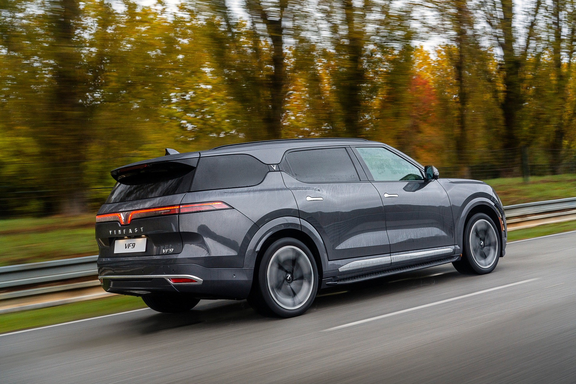 Dark Grey Vinfast EV SUV V9 rear view driving on the road