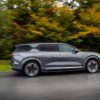 Dark Grey Vinfast EV SUV V9 rear view driving on the road