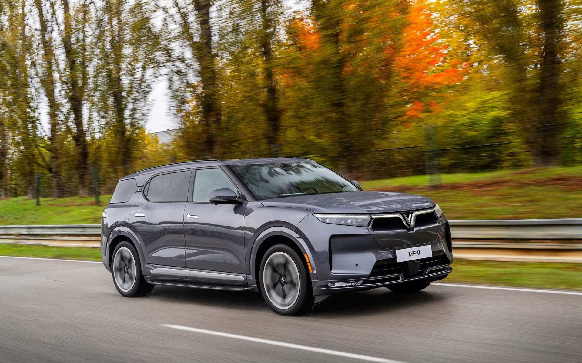 VinFast VF9 Driving on the road in the fall