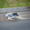 Car driving through deep water on the road